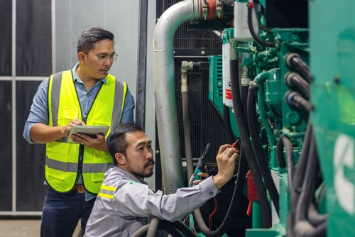 Two technical workers with tablets working in an industry factor
